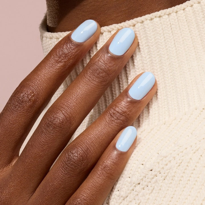 A bottle of MANUCURIST - GREEN™ Nail Polish in Bubble by MANUCURIST INC, featuring a blue and cream label with “Quick Dry Intense Color” and a black cap.