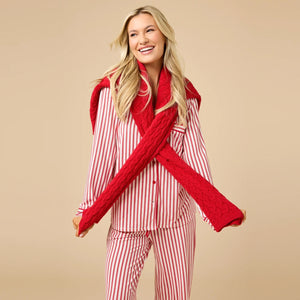A woman wears the SOFTIES ARIA SLIM NOTCH COLLAR PJ SET, featuring a long-sleeved button-down top and matching wide-leg pants in red and white vertical stripes with red piping details.