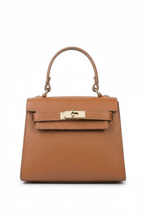 The LE BORSETTE LEATHER SATCHEL BAG is a small, structured satchel-shaped handbag in light pink, featuring a gold clasp at the front. It boasts a single top handle, an adjustable shoulder strap, and two gold-tone hardware pieces on either side of the handle. The textured leather adds to its luxurious and elegant appearance against the plain white background.