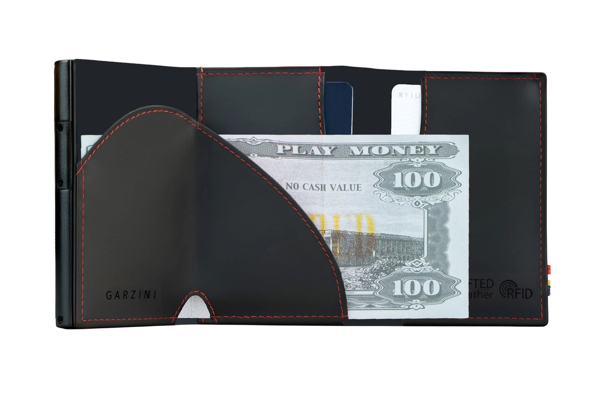 A closed GARZINI - SLIM TRIFOLD RFID-BLOCKING LEATHER WALLET WITH METAL CARD HOLDER AND COIN POCKET IN CARBON WITH RED sits beside a black "GARZINI" pen, both viewed from the side.