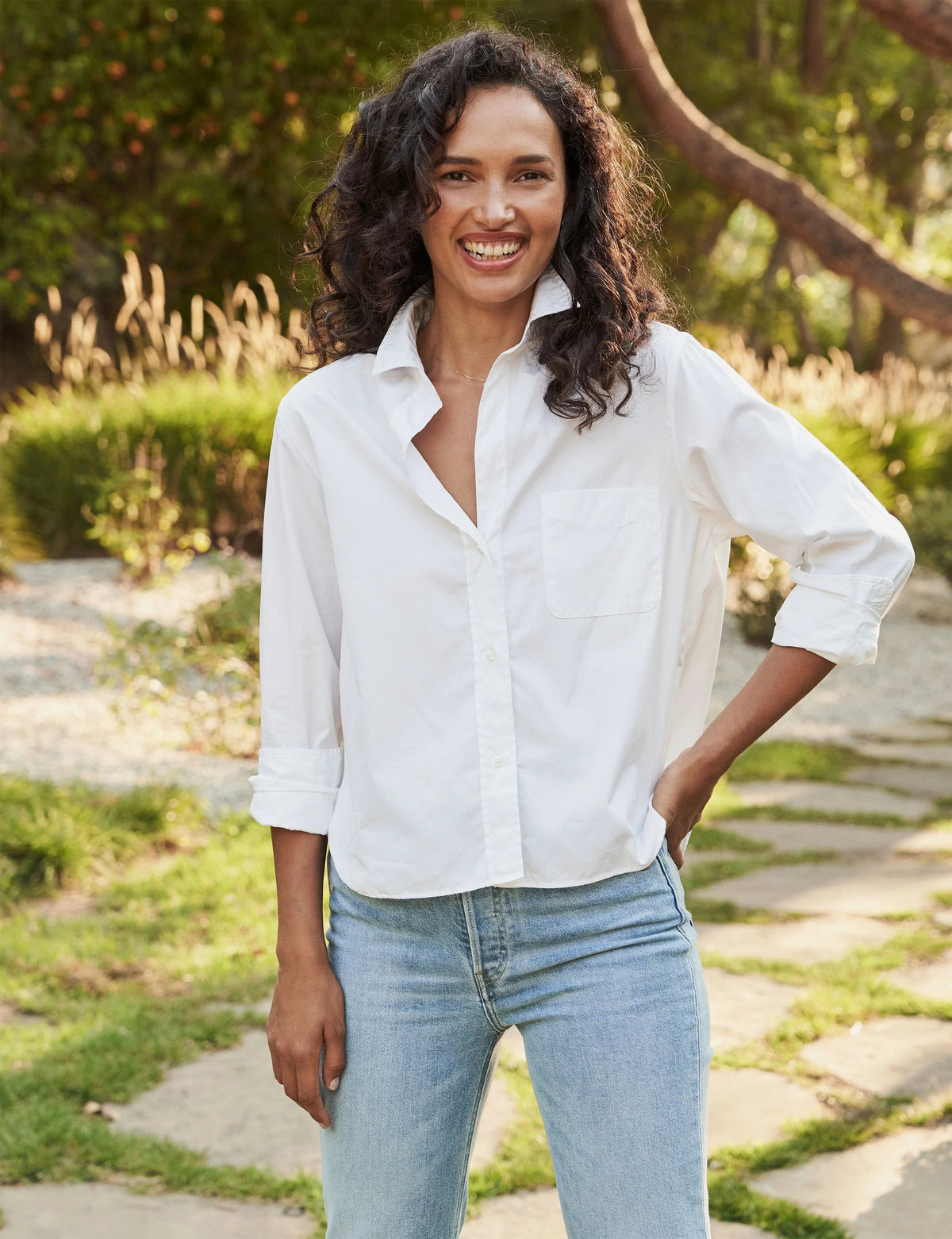 The FRANK &amp; EILEEN Silvio Untuckable Button-Up Shirt in Superluxe Cotton, featuring a chest pocket and rolled-up sleeves, is laid flat on a textured surface. The inside label reads "Frank &amp; Eileen EST 1947.