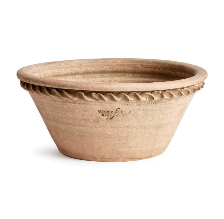 The NAPA HOME AND GARDEN - WAKEFIELD HENLEY FORCING POT is a round, shallow terracotta pot with a flared rim, rope-like edge detail, rough natural finish, and “Wakefield Handmade” stamped on the side.