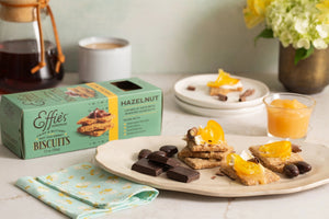 EFFIES - HAZELNUT BISCUIT by EFFIES HOMEMADE comes in a box featuring an image of stacked biscuits topped with jam. The packaging describes them as “crisp & buttery, not too sweet,” and highlights their “layers of oats with roasted hazelnuts.” Enjoy these wholesome biscuits on their own for a satisfying crunch of oats and roasted hazelnuts in every bite, or pair them perfectly with a touch of bittersweet chocolate.