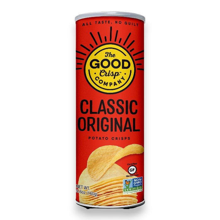 A cylindrical canister of THE GOOD CRISP COMPANY - CLASSIC ORIGINAL CHIPS. This red container, adorned with black and yellow text, showcases a serving of crisps. It boasts gluten-free and non-GMO certifications on the lower front. Perfect for snacks, its net weight is 5.6 oz.