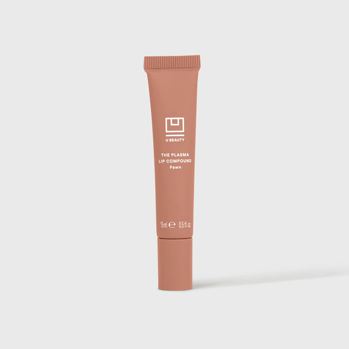 A close-up shows glossy, peachy-pink lips enhanced with U BEAUTY’s PLASMA LIP COMPOUND IN FAWN, gently touched by a finger.