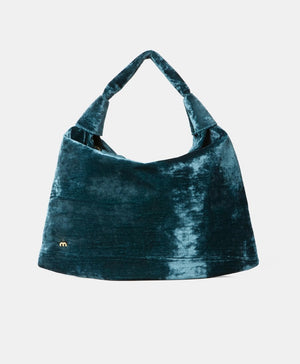 The MOMONI - FRANCOIS VELVET BAG by MOMONI is a teal hobo bag with a slouchy design and a single handle. Made in Italy, it features a small, gold "m" logo on the lower left side. The bag has an overall soft and plush texture, crafted from luxurious crushed viscose velvet.