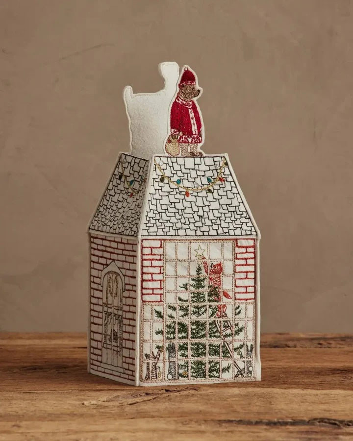 HOME FOR THE HOLIDAYS TISSUE BOX COVER shaped like a house, featuring an embroidered Christmas tree, string lights, and a teddy bear in a Santa hat for festive holiday home decor.
