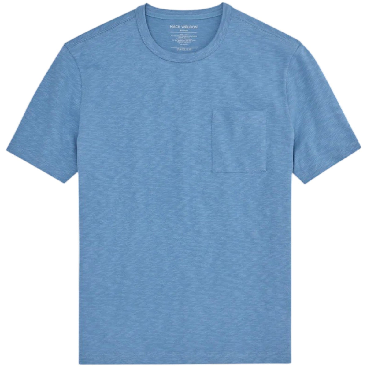 A man with short curly hair wears the MACK WELDON Heavyweight Slub Cotton Pocket T-Shirt in Dean Blue with dark pants, standing against a plain white background.