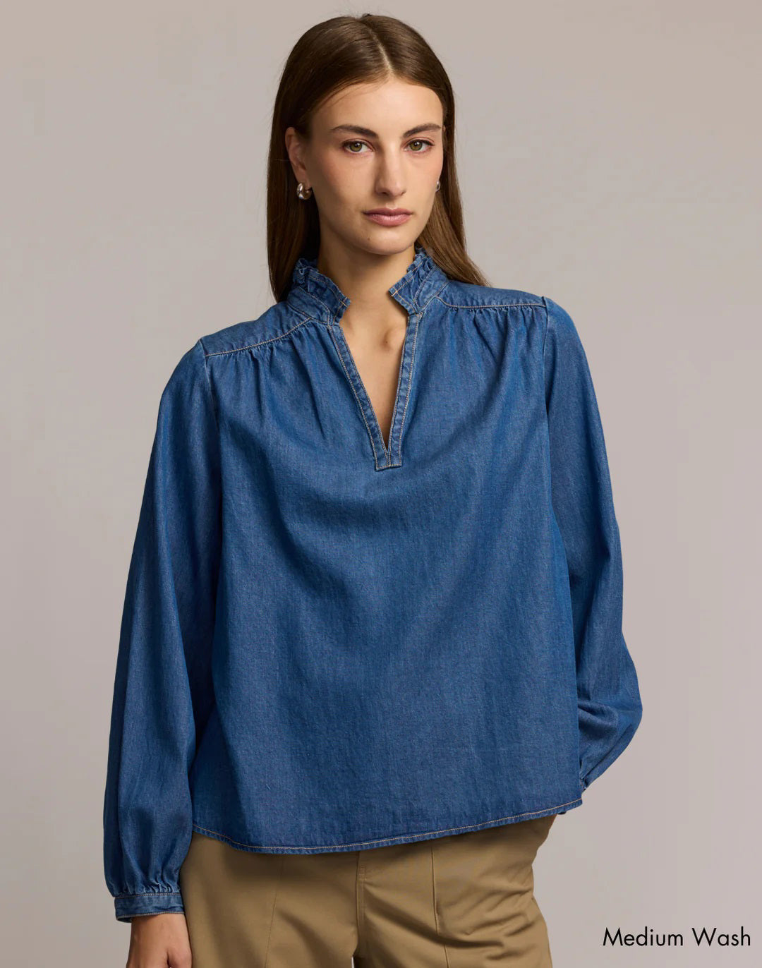 A woman with straight brown hair models the HINSON WU Vanessa Long Sleeve Denim Shirt and tan pants against a plain background.
