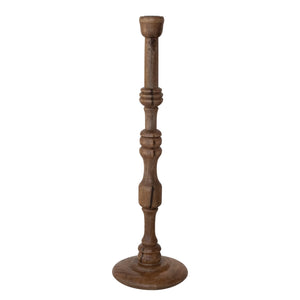 The TURNED MANGO WOOD TAPER HOLDER, MEDIUM by CREATIVE COOP features a tall, slender design with a round base, carved details, and a natural mango wood finish crafted in traditional turned woodwork.