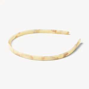 The MACHETE Ultralight Thin Headband in Creme is a sleek, lightweight Italian acetate accessory featuring a subtle marbled pattern in a creamy hue, shown against a plain white background.