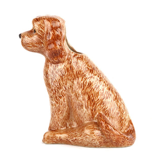 The QUAIL DESIGNS QUAIL CERAMICS Cockapoo Dog Flower Vase features a hand-painted brown, curly-haired dog with black eyes and nose, sitting upright against a plain white background.