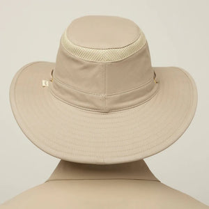 A man with a gray beard wears the TILLEY - AIRFLO HIKERS HAT T4MO-1 IN KHAKI OLIVE, featuring UPF 50+ sun protection, and a matching collared shirt, shown in profile against a plain light background.