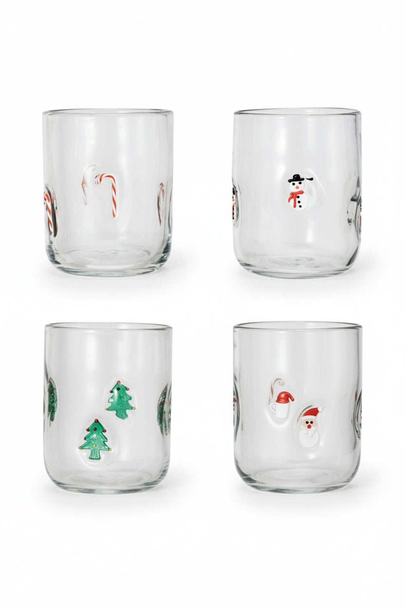 Four clear DRINKING GLASS WITH HOLIDAY ICON glasses, each decorated with small, raised icons including Christmas trees, snowmen, and candy canes.