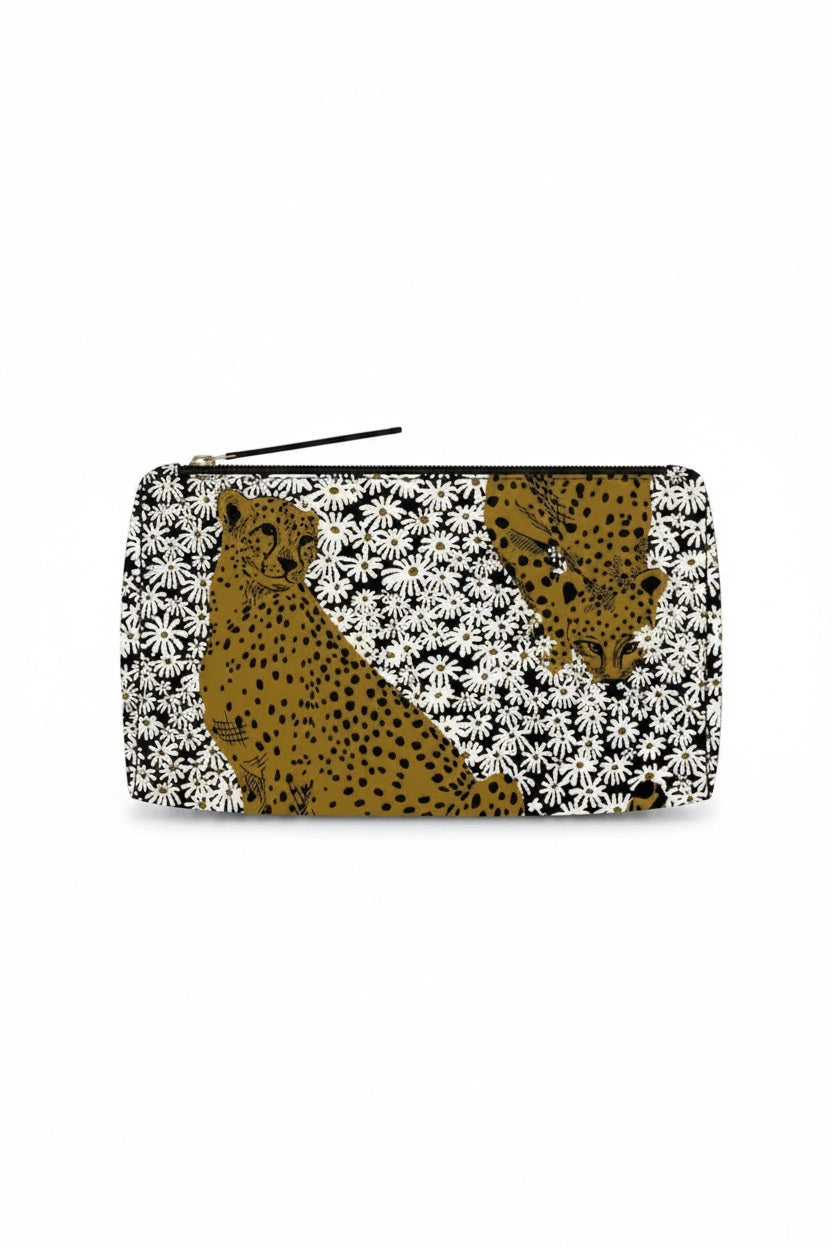 The INOUI EDITIONS - PAMPAS COSMETIC POUCH by INOUI is a rectangular zipper pouch expertly crafted from durable nylon cosmetic pouch material. It showcases a bold pattern of two cheetahs surrounded by dense white daisy-like flowers set against a black background. Made in India, this stylish pouch blends practicality with distinctive design.