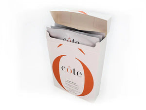 A white rectangular box partially open at the top, revealing multiple sheet masks inside, along with a special foot mask for age-defying hydration. The box is labeled with the brand name "COTE" and adorned with orange design accents. It contains "COTE - FOOT MASK WITH COLLAGEN 3 PACK.