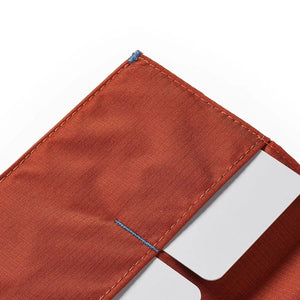 An ultra-slim, closed ALLETT wallet in RFID-blocking Potter’s Clay nylon, featuring a small gray or light blue "A" logo on the bottom right, shown on a white background.