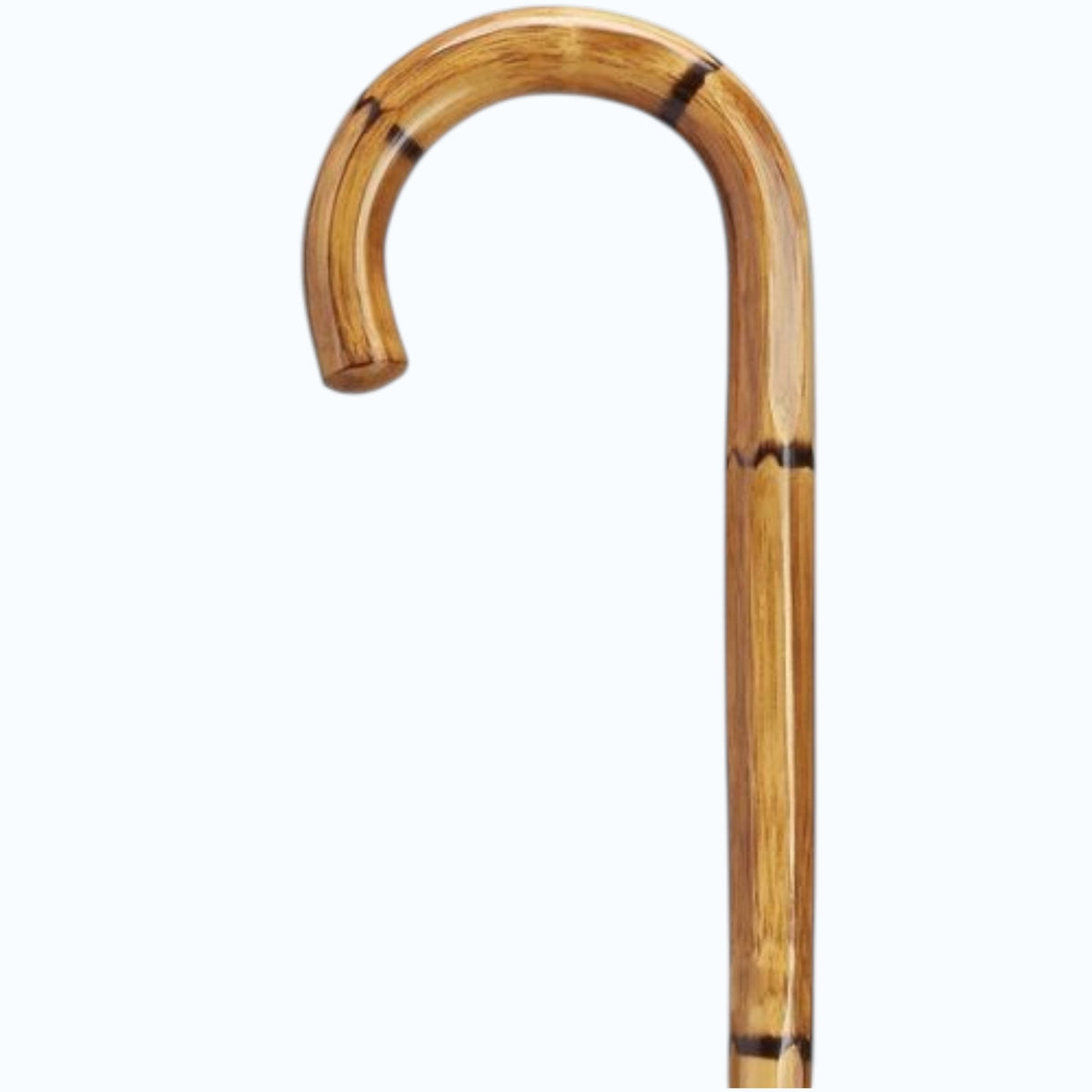 The HARVY CANES Imported Crook Handle Manilla Cane features a carved hexagon wood shaft, a curved handle, and a natural brown finish with distinctive darker bands.