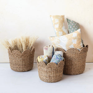 The CREATIVE COOP BRAIDED BANKUAN & RATTAN BASKET (SMALL), crafted from natural fibers with scalloped edges, is displayed against a white background.