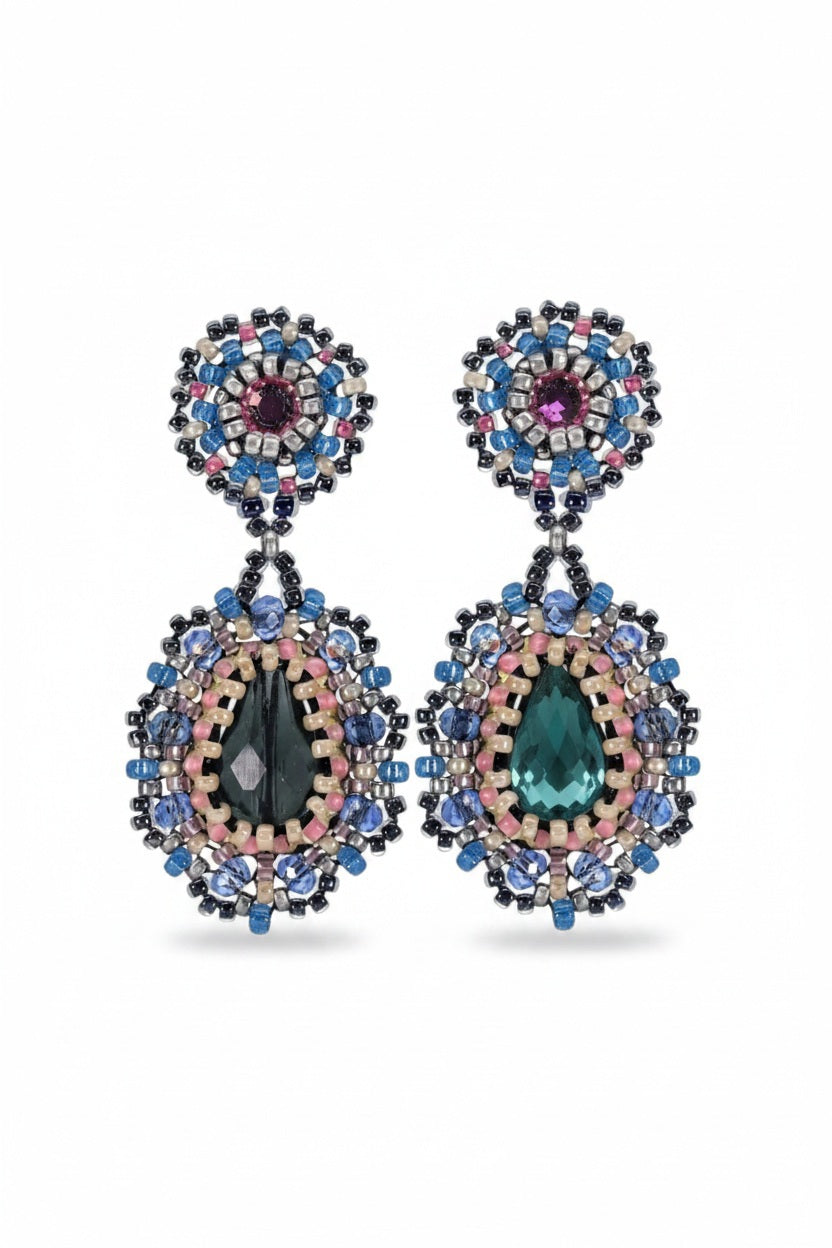 The MIGUEL ASES - CRYSTAL MIYUKI DROP EARRINGS by MIGUEL ASES, INC. are elegant luxury earrings featuring oval dark green gemstones and intricate patterns of Miyuki crystal beads in blue, pink, and gray with a circular top section and teardrop-shaped dangle.