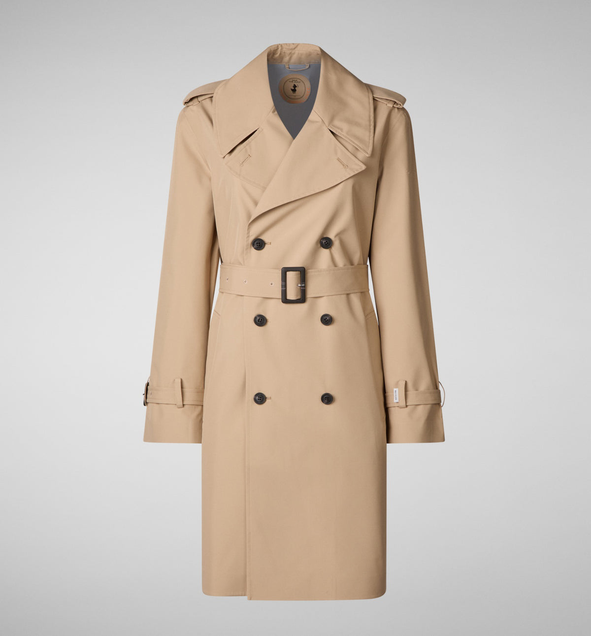 The SAVE THE DUCK - TAYLA TRENCH COAT is a beige water-repellent twill, double-breasted trench with a belted waist, wide lapels, epaulets, and buttoned sleeve cuffs, shown against a plain light gray background.