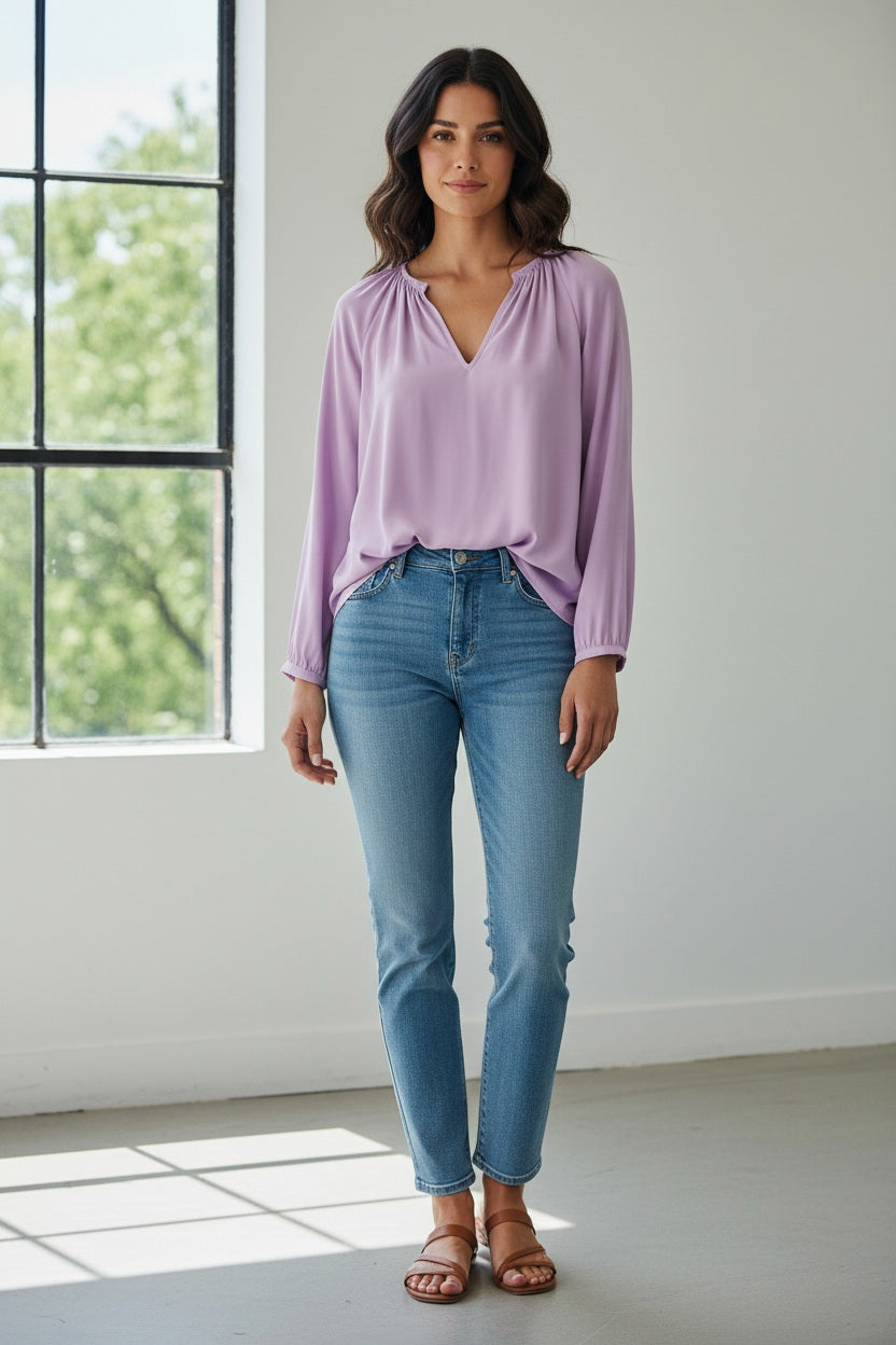 The MOMONI LARICE SHIRT is a long-sleeved, light purple bohemian blouse featuring a gathered neckline, subtle V-front slit, and loose fit, shown on a white background.
