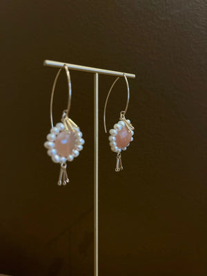 GOLDISH - Floral Gemstone Earrings in Pink Moonstone and White Pearl feature delicate 14K gold fill fringe beneath pink moonstones and white pearls, displayed on a white stand for an elegant look.
