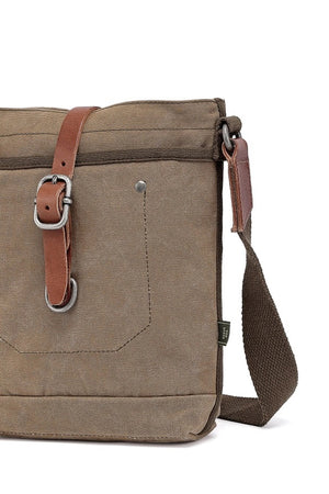 The TSD BRAND - FOREST ZIP CROSSBODY BAG IN OLIVE is a military-inspired khaki canvas bag with a front pocket, brown adjustable strap, decorative leather buckle, metal rivets, and textured shoulder strap for style and durability.