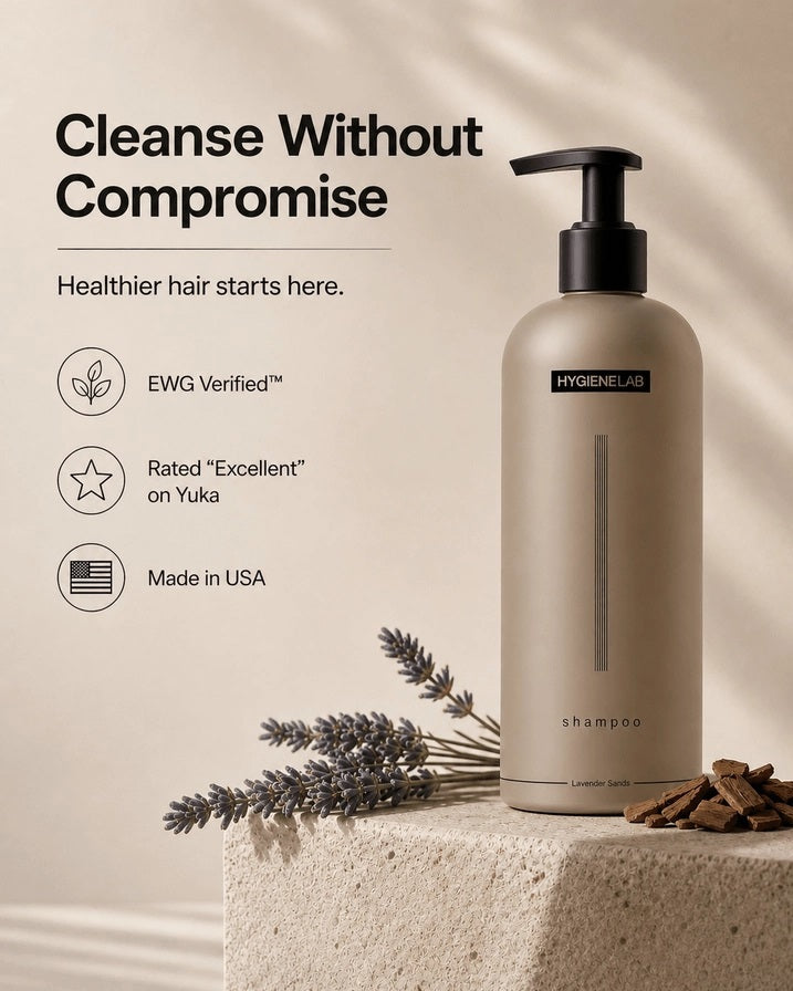 A beige bottle of HYGIENELAB - SHAMPOO, LAVENDER SANDS features a black pump dispenser, minimalist vertical lines, and the scent “Lavender Sands” indicated at the bottom.