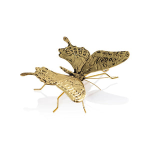 Two ZODAX DECORATIVE ANTIQUE GOLD BUTTERFLY - LARGE figurines rest on a white rectangular zinc alloy container with a metallic handle, displayed on a textured light gray surface.