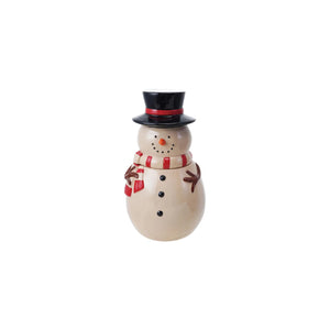 A CREATIVE COOP SNOWMAN JAR WITH LID, featuring a red scarf, black hat, and painted smile, is split in half on a beige surface with white pebbles spilling out between the head and body.