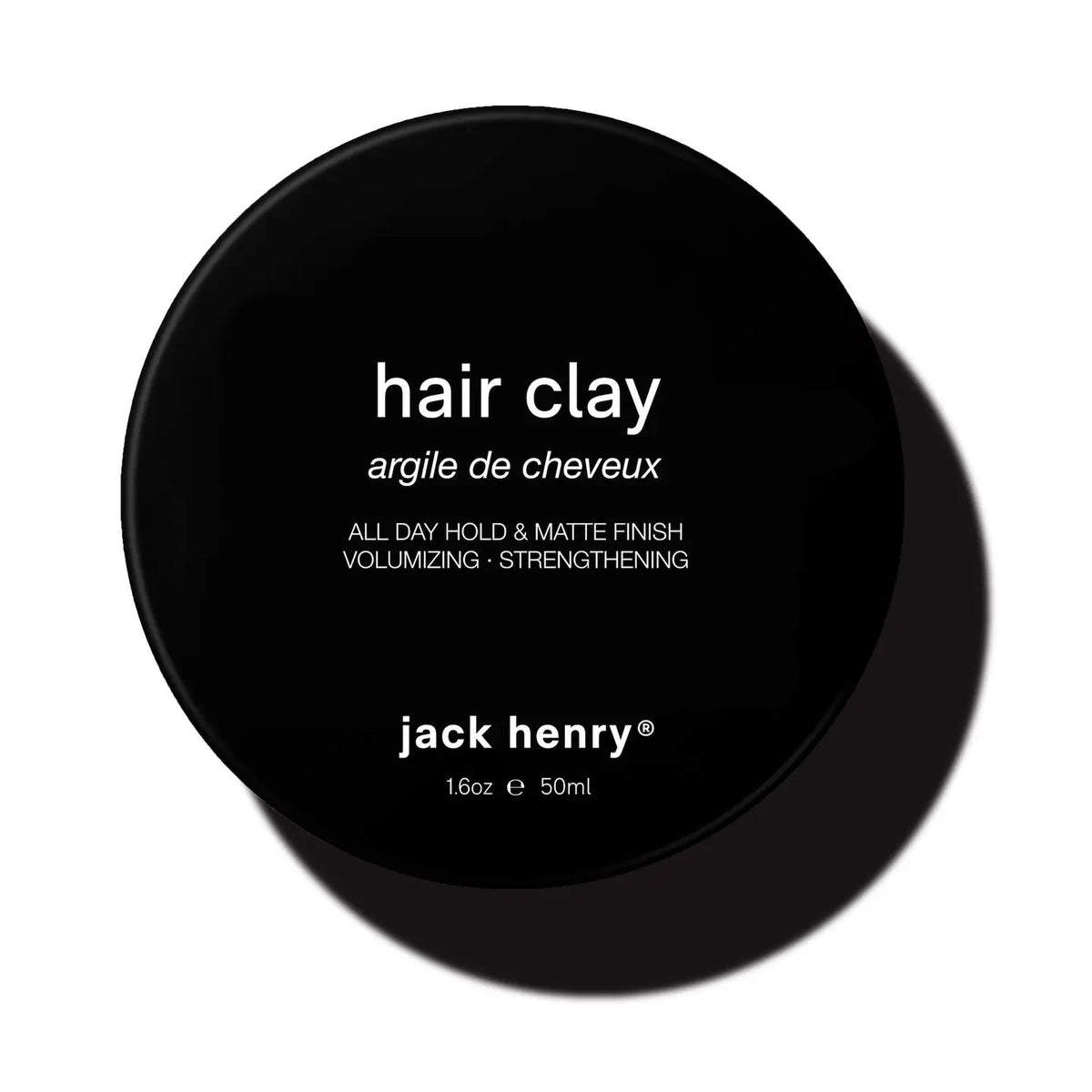 JACK HENRY - HAIR CLAY: A black circular container with white text, delivering all-day hold, volumizing matte finish, and hair-strengthening benefits to support growth. Size: 1.6oz / 50ml.