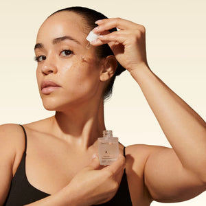 A frosted glass dropper bottle labeled “OMNILUX – PEPTIDE CONCENTRATE” features silver text and an orange starburst logo, containing 30 mL (1 fl oz) of skincare formula from OMNILUX enriched with powerful ingredients such as Argireline and Matrixyl.