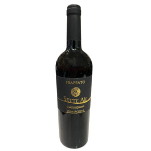 A bottle of CANTINE GRASSO FRAPPATO 2025 red wine with a black label, standing on a white surface in front of wine store shelves.
