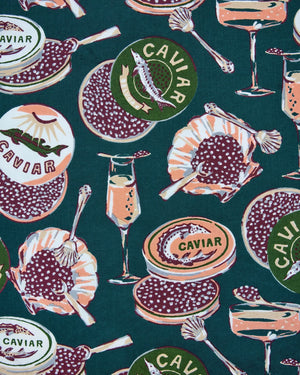 Adorned with an illustrated pattern of caviar tins, open shells brimming with caviar, delicate spoons, and tall champagne glasses on a rich peacock feather green background, the PRINTFRESH - CHAMPAGNE & CAVIAR QUILTED POUCH IN PEACOCK FEATHER is an elegant accessory from PRINTFRESH. This stylish pouch makes a perfect gift for her.