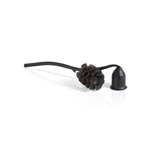The ZODAX PINE CONE DESIGN WROUGHT IRON CANDLE SNUFFER features a sturdy dark metal build, a pinecone-shaped handle, and a bell-shaped tip, shown on a white background.
