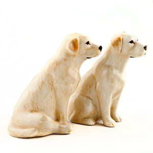 The QUAIL CERAMICS - GOLDEN LABRADOR SALT AND PEPPER SET by QUAIL DESIGNS features two handpainted stoneware golden Labradors with realistic details and a glossy finish, perfect for adding charm to your table.
