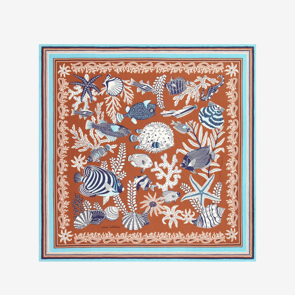 The INOUI EDITIONS - NEPTUNE SCARF IN GOLDEN BROWN by INOUI features detailed blue and white tropical fish, seaweed, shells, and coral on a brown background with an intricate blue, white, and brown border in cotton silk.