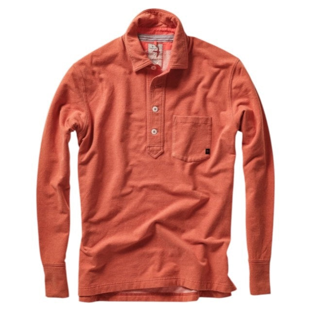 Close-up of the RELWEN Mariner Polo in Orange Fade, crafted from soft French terry, featuring white buttons, a collar, and a glimpse of the inner tag with striped fabric detail.