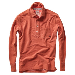 Close-up of the RELWEN Mariner Polo in Orange Fade, crafted from soft French terry, featuring white buttons, a collar, and a glimpse of the inner tag with striped fabric detail.