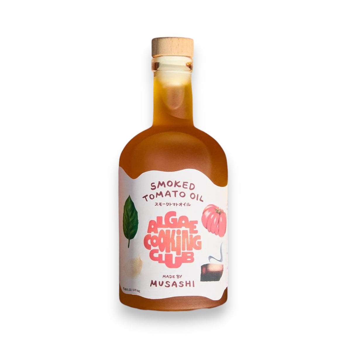 A glass bottle labeled “ALGAE COOKING CLUB - MUSASHI’S SMOKED TOMATO OIL” featuring illustrations of tomato and basil, with a wooden cap, contains amber-colored oil. Produced by ALGAE COOKING CLUB, this oil is ideal for adding a rich, savory grilled tomato flavor to your dishes.