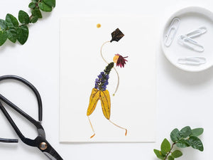 The PETAL PEOPLE PRESS - PICKLEBALL GREETING CARD by Petal People Press features a whimsical figure made of pressed flowers and leaves on a white background, posed dynamically with a black leaf racket and yellow flower ball, resembling an elegant pickleball moment.