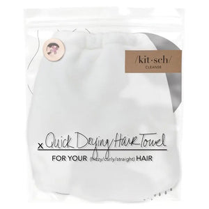 The KITSCH - QUICK DRY HAIR TOWEL, suitable for frizzy, curly, or straight hair, comes in a clear plastic bag labeled "/kit·sch/ CLEANSE," and boasts quick-drying microfiber that effectively reduces frizz.
