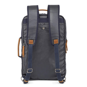 The TSD BRAND - MADRONE COATED CANVAS BACKPACK IN NAVY features brown leather accents, a spacious main compartment, a padded laptop sleeve with snap closure, and multiple zippered pockets on the inside flap.