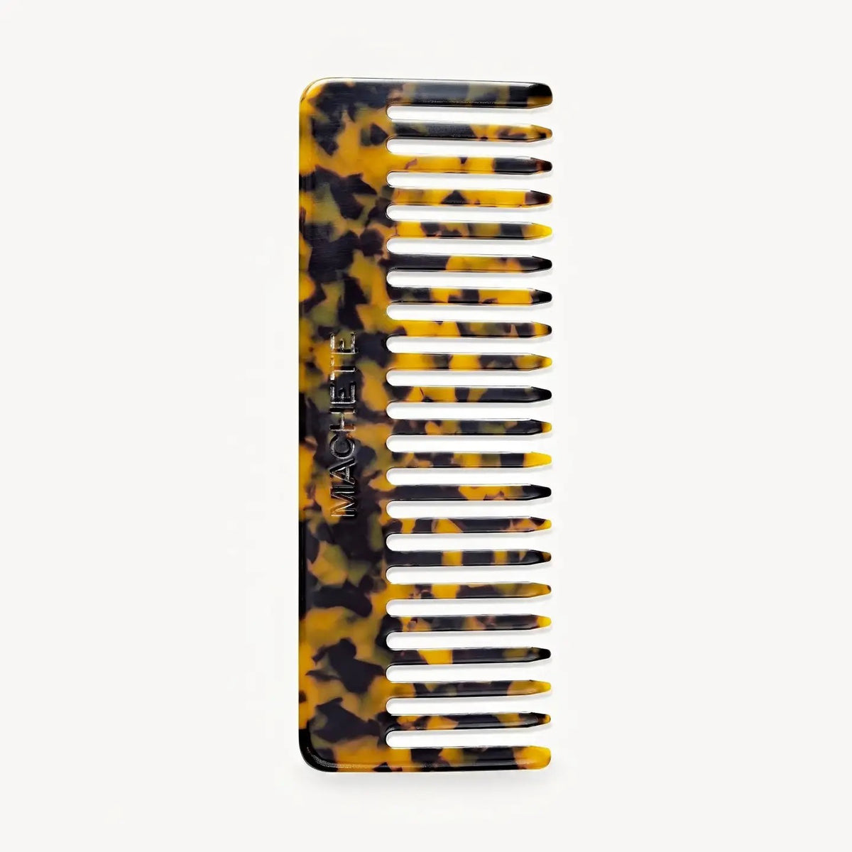 The MACHETE - NO2 Comb in Tortoise features wide teeth and a tortoiseshell pattern, handcrafted from Italian acetate with "MACHETE" engraved on the side, shown against a plain white background.