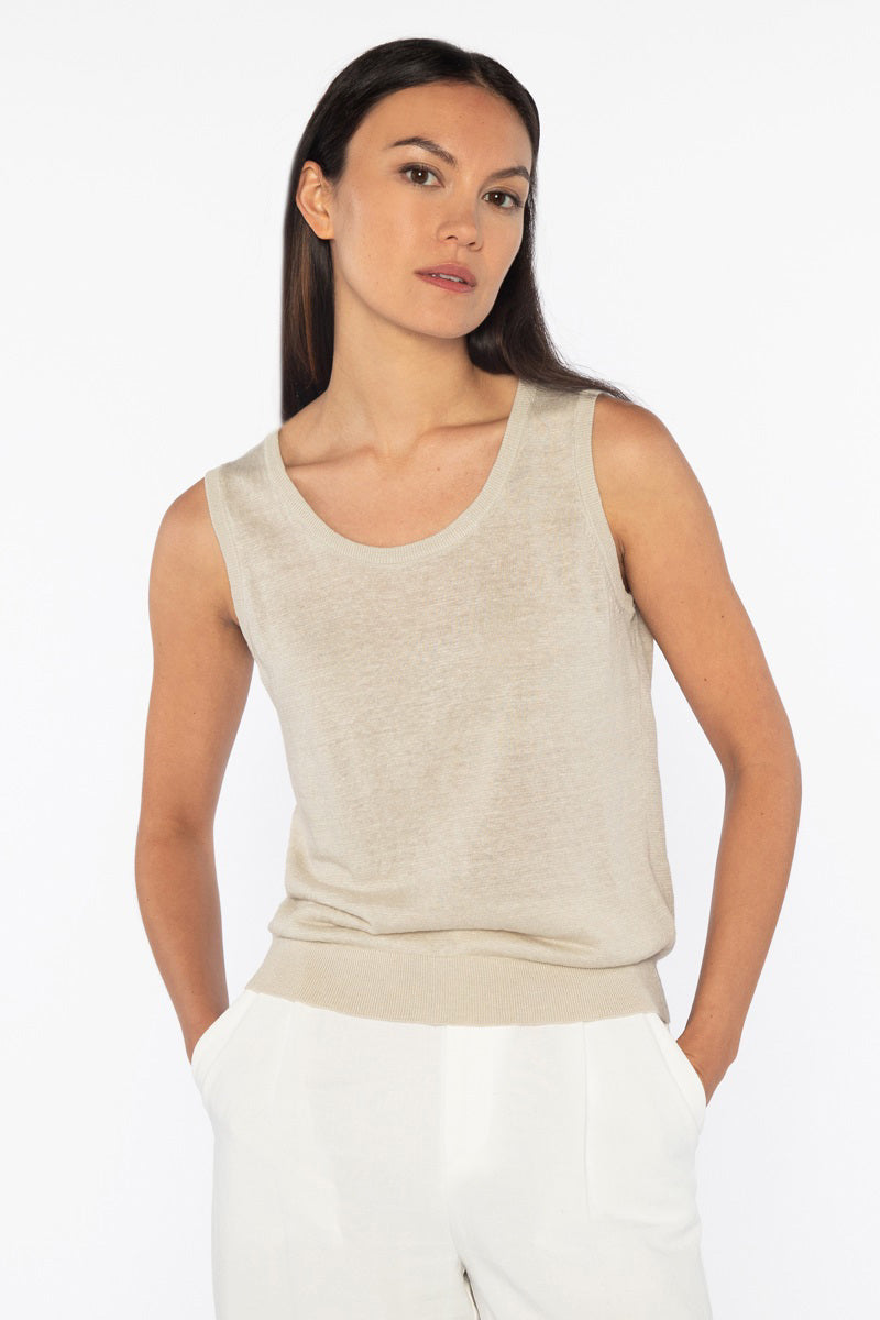 Close-up of the KINROSS Cashmere Sleeveless Tank in Linen, featuring pink knitted fabric with detailed interlocking stitches. The uniform pattern and soft yarn make it a versatile piece, adding cozy warmth to any effortless everyday style.