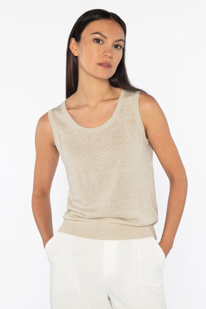 Close-up of the KINROSS Cashmere Sleeveless Tank in Linen, featuring pink knitted fabric with detailed interlocking stitches. The uniform pattern and soft yarn make it a versatile piece, adding cozy warmth to any effortless everyday style.