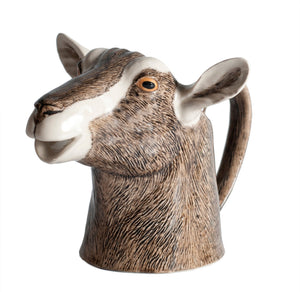 The QUAIL CERAMICS - GOAT JUG MEDIUM by QUAIL DESIGNS is a handpainted stoneware mug shaped like a goat’s head with detailed brown and white fur, upright ears, and a neck-shaped handle inspired by the British Toggenburg Goat jug.