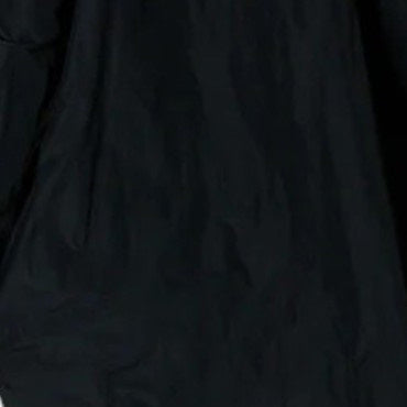 A close-up of KATHARINA HOVMAN&#39;s Easy Pants in anthracite taffeta reveals a textured, possibly dark fabric with a crumpled surface and hints at an elastic waistband due to lighting variations.