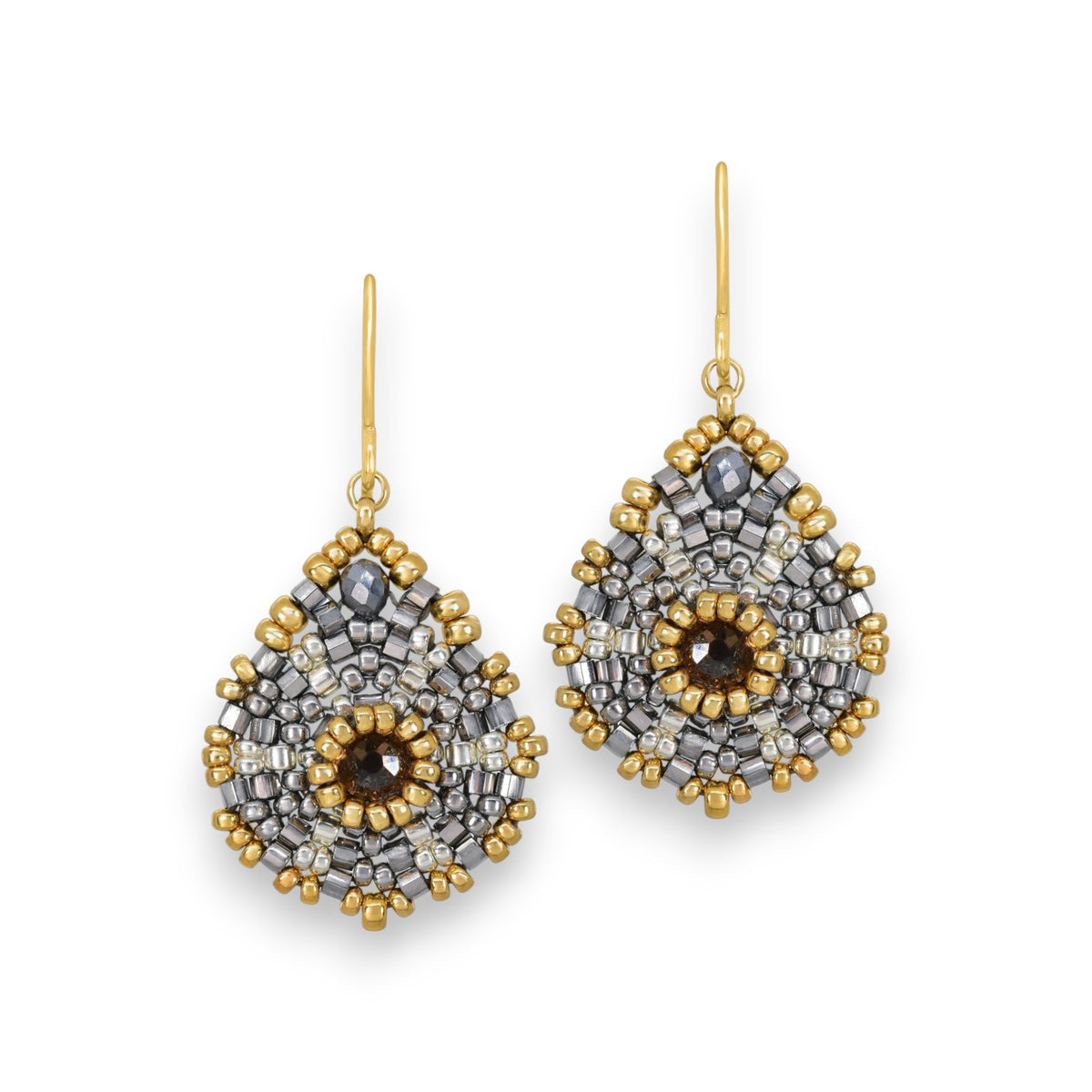 Introducing the MIGUEL ASES Miyuke Crystal Pyrite Earrings: elegant, teardrop-shaped earrings featuring a central dark stone surrounded by silver and gold beads in a symmetrical design, complete with hook attachments. Crafted by MIGUEL ASES, INC., they exude handcrafted sophistication.